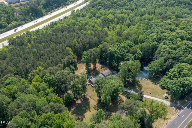 birds eye view of property with a forest view