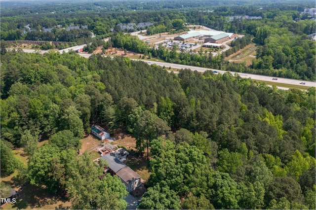 drone / aerial view featuring a forest view