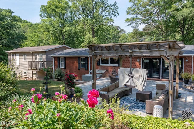 back of property featuring a pergola, a patio, an outdoor living space, and brick siding