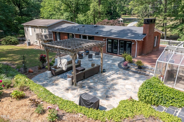 back of house with outdoor lounge area, french doors, a chimney, brick siding, and a patio area