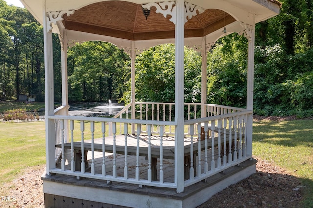 wooden terrace with a yard and a gazebo