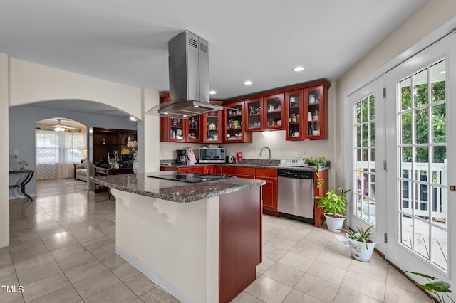 kitchen with island range hood, a breakfast bar area, appliances with stainless steel finishes, and a healthy amount of sunlight