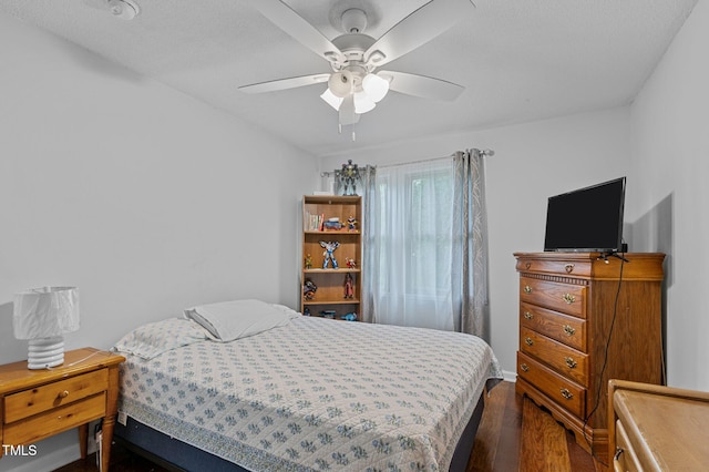 bedroom with ceiling fan and dark hardwood / wood-style floors