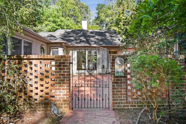 view of gate with a fenced front yard