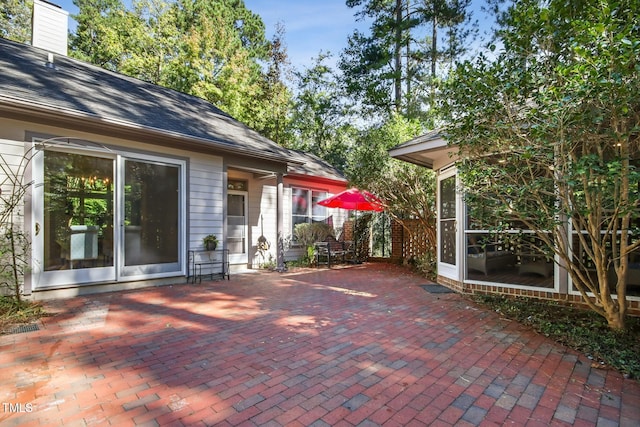 view of patio / terrace featuring a sunroom
