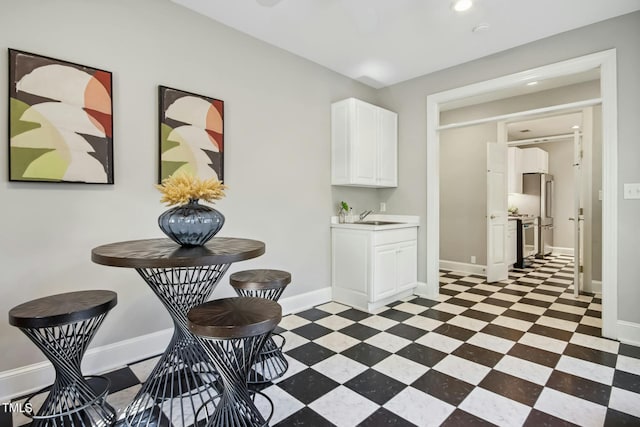 kitchen featuring sink and white cabinets