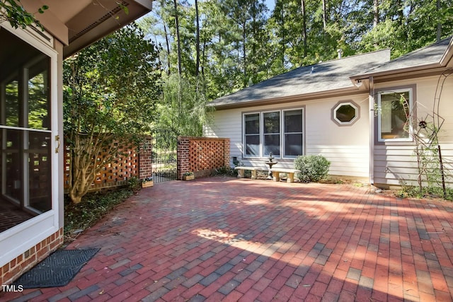 view of patio with a gate and fence