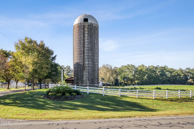 surrounding community featuring a lawn and a rural view