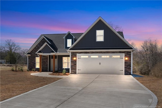 craftsman house with a garage, stone siding, board and batten siding, and concrete driveway