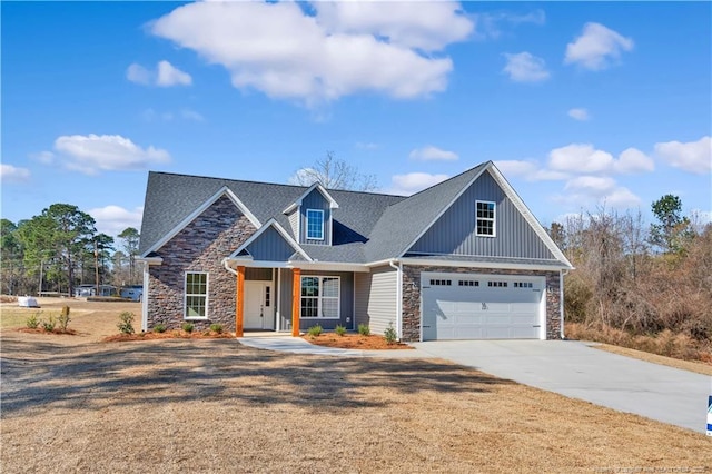 view of front of house with driveway, stone siding, a garage, and board and batten siding