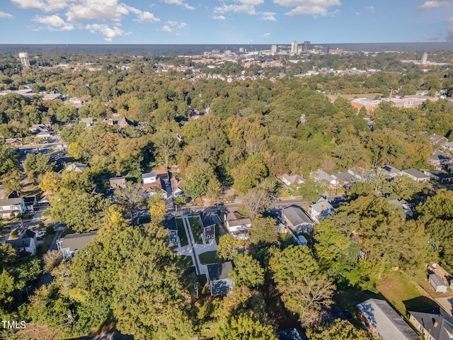 bird's eye view with a wooded view
