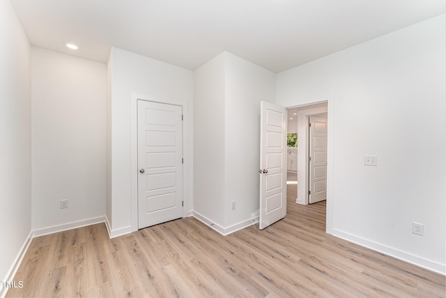 unfurnished bedroom with baseboards, recessed lighting, and light wood-style floors