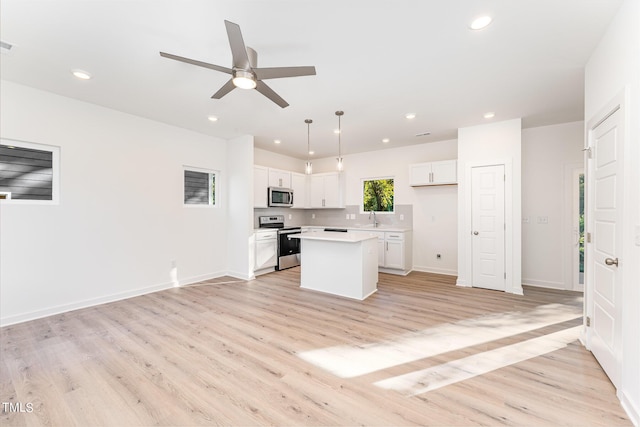 112 N Guthrie Ave Unit A, Durham, NC 27703 - kitchen with appliances with stainless steel finishes, ceiling fan, light wood finished floors, white cabinets, and recessed lighting