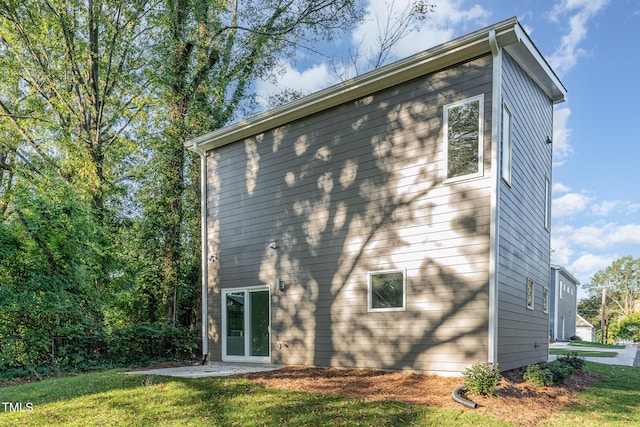 rear view of house featuring a yard