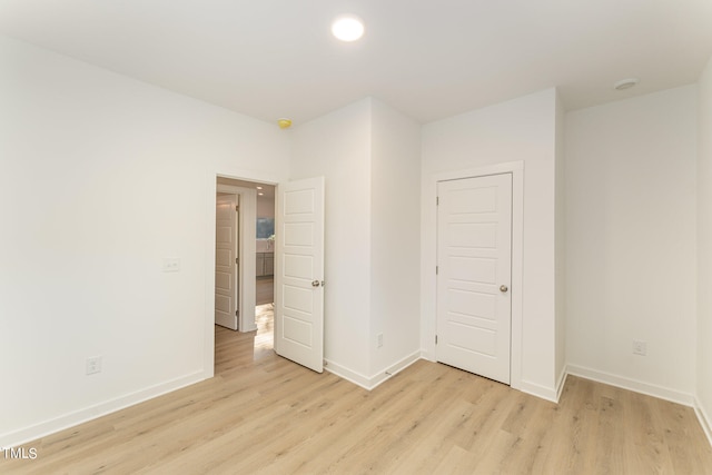 unfurnished bedroom featuring a closet and light hardwood / wood-style floors