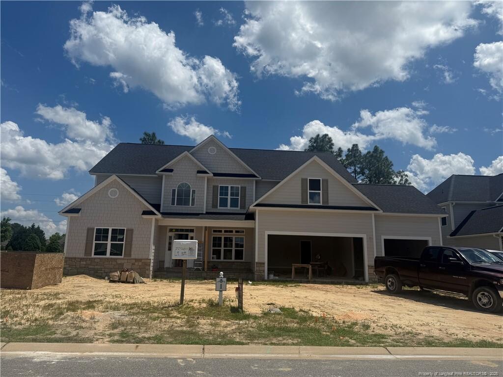2929 Cragburn Pl, Fayetteville, NC 28306 - craftsman inspired home with driveway, stone siding, and a garage