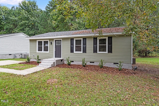 view of front of house featuring a front yard and central AC unit