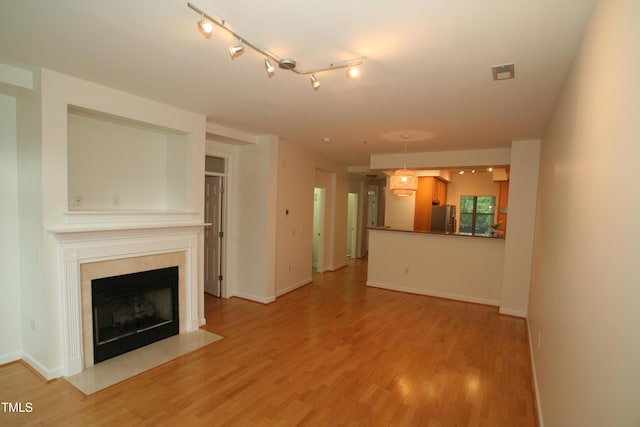 1001 Hillsborough St Unit 304, Raleigh, NC 27603 - unfurnished living room with light wood-style flooring and a fireplace with flush hearth