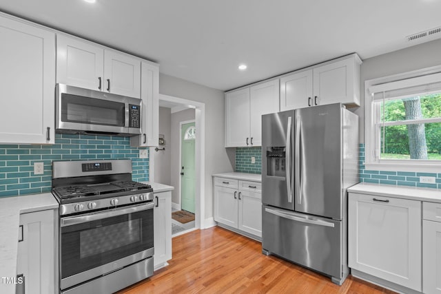 1209 Edgevale Rd, Durham, NC 27701 - kitchen with appliances with stainless steel finishes, light countertops, white cabinetry, tasteful backsplash, and recessed lighting