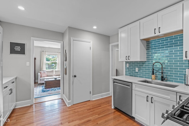 1209 Edgevale Rd, Durham, NC 27701 - kitchen featuring stainless steel appliances, white cabinetry, light wood-style floors, tasteful backsplash, and recessed lighting