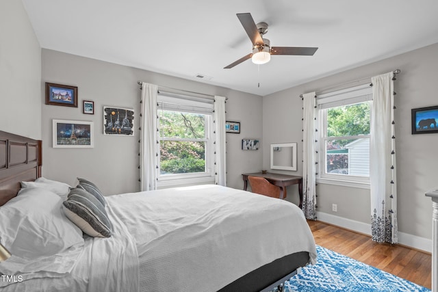 1209 Edgevale Rd, Durham, NC 27701 - bedroom featuring multiple windows, wood finished floors, and ceiling fan