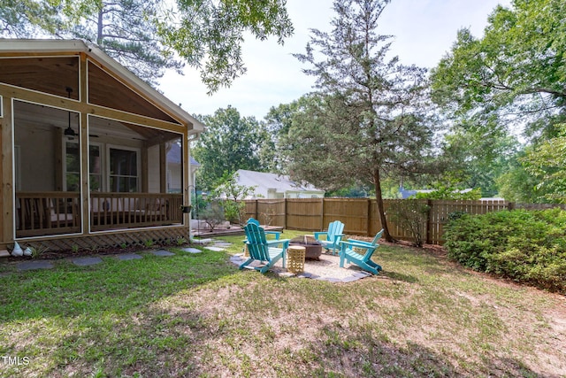 1209 Edgevale Rd, Durham, NC 27701 - fenced backyard with a sunroom, an outdoor fire pit, and a ceiling fan