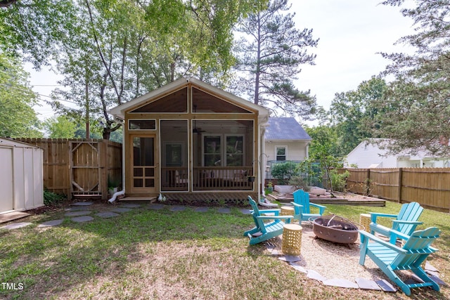 1209 Edgevale Rd, Durham, NC 27701 - rear view of property with a sunroom, an outdoor fire pit, and a fenced backyard