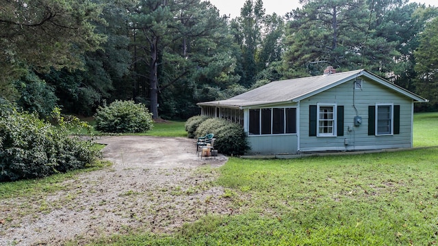 view of side of home with a yard