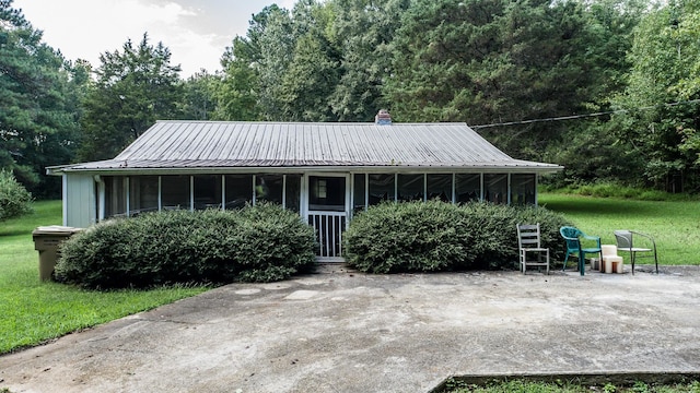 view of front facade featuring a front yard and a sunroom