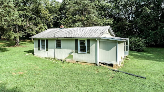 view of outbuilding featuring a lawn