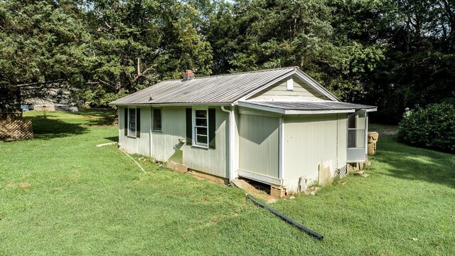 view of outbuilding with a yard