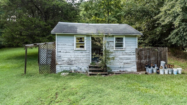 view of outbuilding featuring a lawn