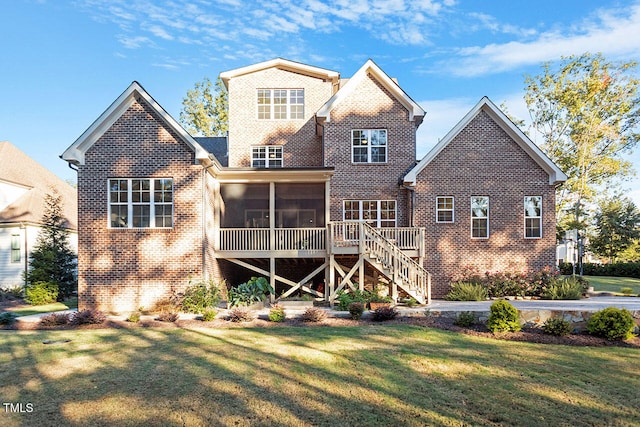 rear view of house featuring a sunroom and a lawn