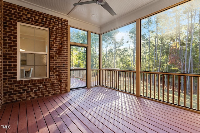 unfurnished sunroom featuring ceiling fan