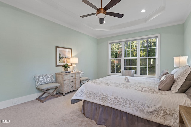 bedroom with carpet, a raised ceiling, crown molding, and ceiling fan