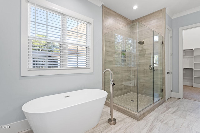 bathroom with ornamental molding and independent shower and bath