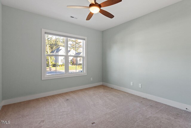 spare room with light carpet and ceiling fan