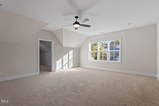 additional living space featuring light carpet, vaulted ceiling, and ceiling fan