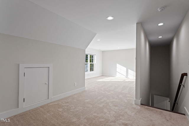 bonus room featuring light carpet