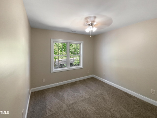 carpeted spare room featuring ceiling fan