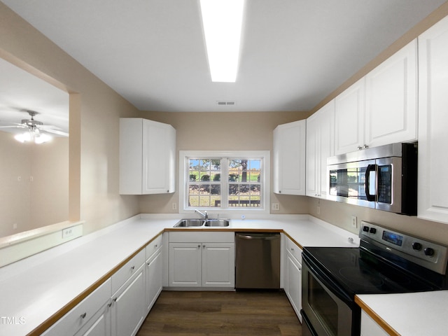 kitchen featuring ceiling fan, sink, white cabinetry, appliances with stainless steel finishes, and dark hardwood / wood-style flooring