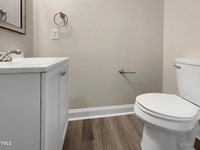 bathroom featuring hardwood / wood-style floors, vanity, and toilet