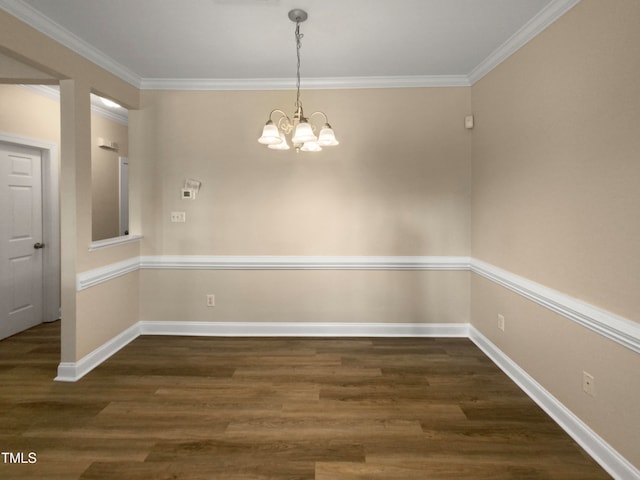 unfurnished dining area featuring an inviting chandelier, dark hardwood / wood-style floors, and crown molding