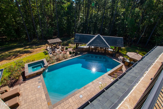 view of swimming pool with a patio and an in ground hot tub