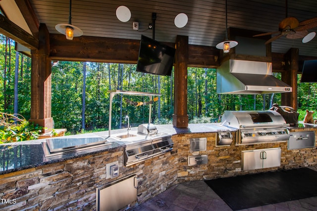 view of patio with ceiling fan, area for grilling, and an outdoor kitchen