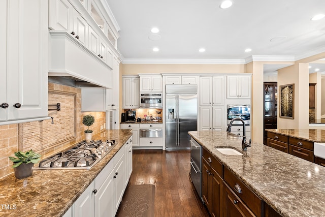 kitchen featuring sink, stainless steel appliances, light stone countertops, dark hardwood / wood-style floors, and white cabinetry