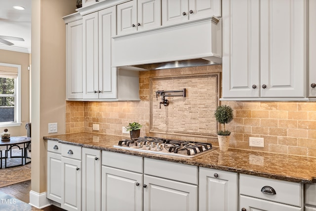 kitchen with stainless steel gas stovetop, premium range hood, dark hardwood / wood-style floors, and white cabinetry