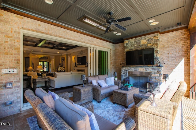 view of patio with ceiling fan and an outdoor living space with a fireplace