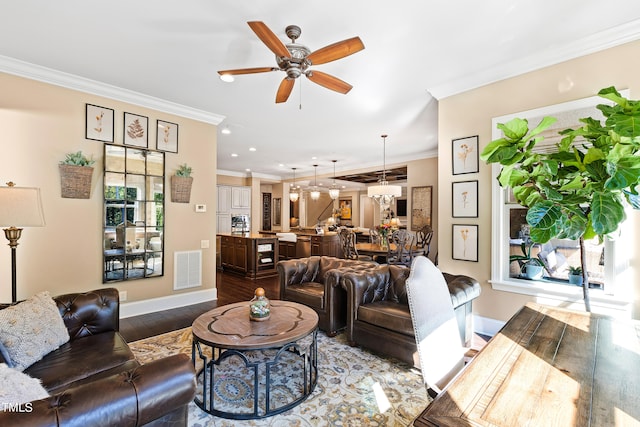 living room featuring wood-type flooring, crown molding, and ceiling fan