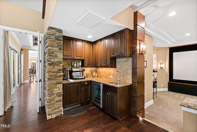 kitchen featuring dark wood-type flooring, backsplash, wine cooler, and sink